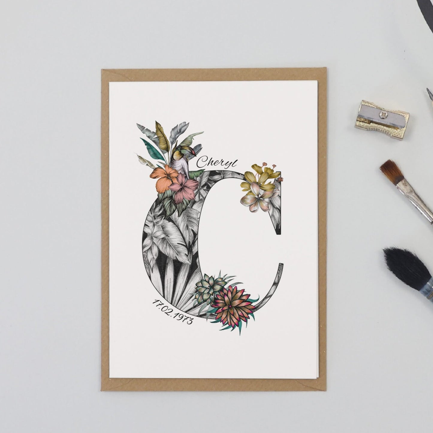 Tropical themed personalised ‘C’ initial birthday card with initial filled with hand-drawn butterflies and flowers. The recipients name and date of birth is incorporated into the design.