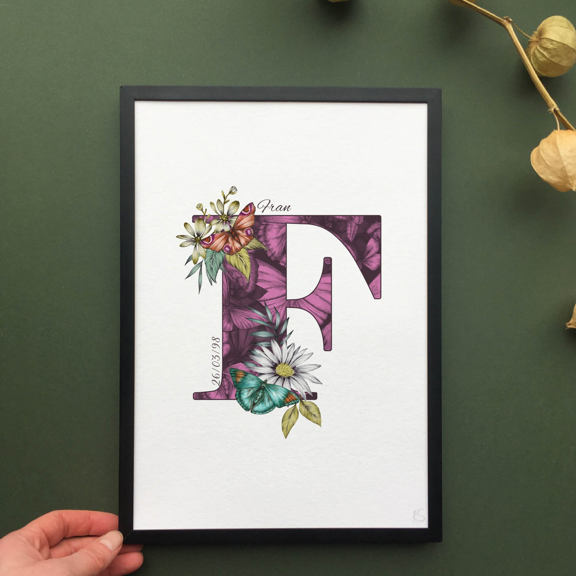 Personalised initial F print is filled with fine liner drawings of butterflies and flowers with a green theme and personalised with the recipients name and date of birth.