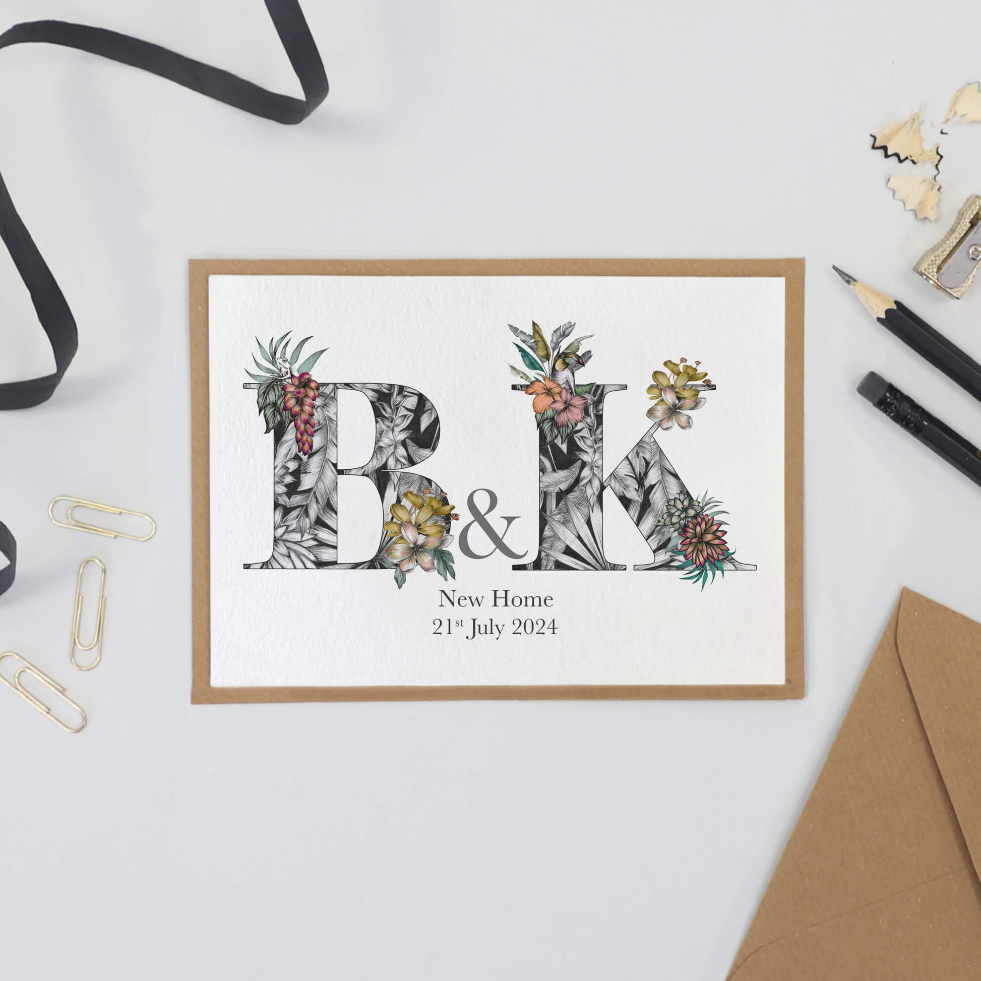 personalised b and k initials housewarming card with with hand-drawn tropical imagery. New home and the couple's moving in date is printed underneath.