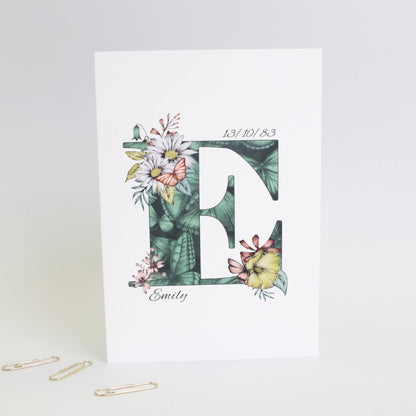 Green butterfly themed personalised ‘E’ initial birthday card with initial filled with hand-drawn butterflies and flowers. The recipients name and date of birth is incorporated into the design.