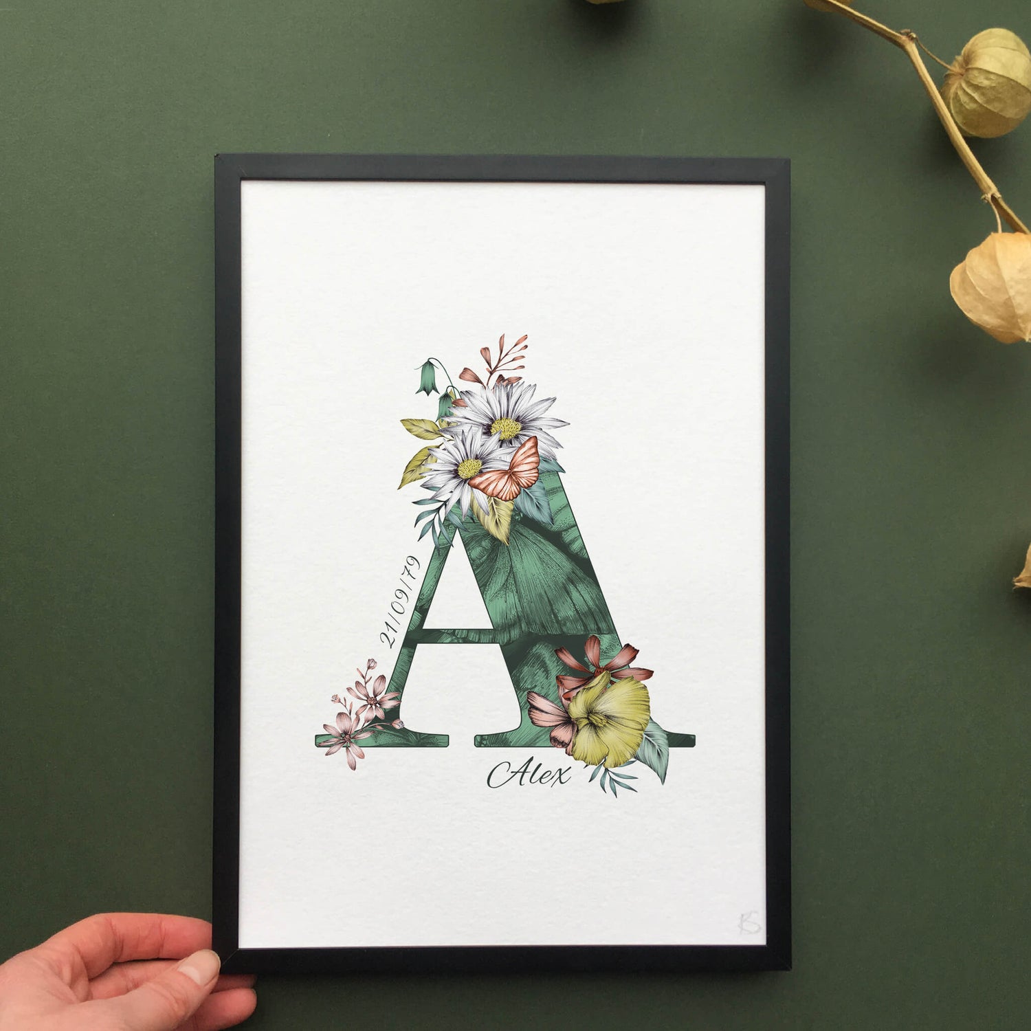 Personalised initial A print is filled with fine liner drawings of butterflies and flowers with a green theme and personalised with the recipients name and date of birth.