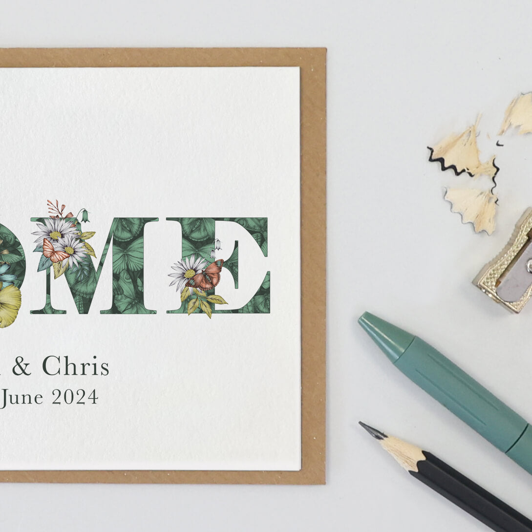 'HOME' printed on a card. Personalised with couples names and moving in date printed underneath.