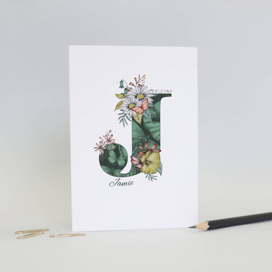 Green butterfly themed personalised ‘J’ initial birthday card with initial filled with hand-drawn butterflies and flowers. The recipients name and date of birth is incorporated into the design.