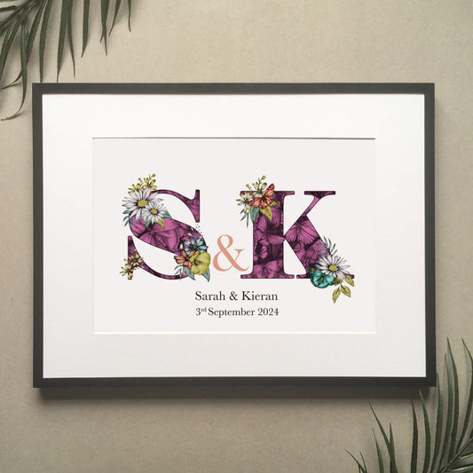 Personalised initial digital print of S & K. Initials are filled with purple fine liner drawings of butterflies and flowers. Under initials ’Sarah and Kieran are printed and under that their wedding date ‘3rd September 2024 is also printed.