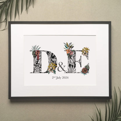 Personalised initial digital print of D & E Initials filled with fine liner drawings of f imagery found in the rainforest. Butterflies, toucan, frog, tropical trees are included. Under initials ‘2nd July 2024’ is printed.