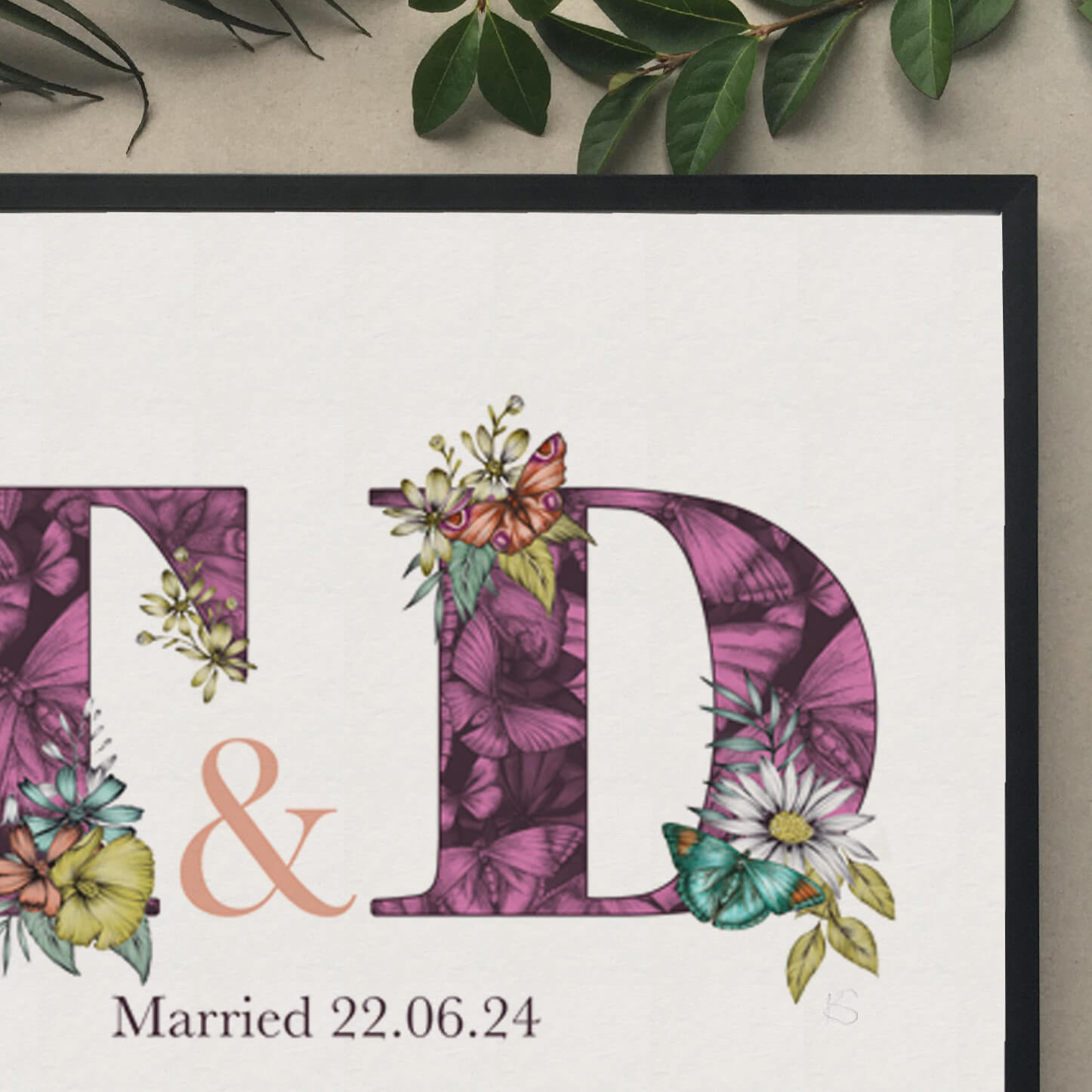 Close up of personalised initial digital print of T & D. Initials are filled with purple fine liner drawings of butterflies and flowers. Under initials married 22.06.24 is printed.